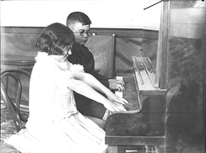 Boy and girl playing piano