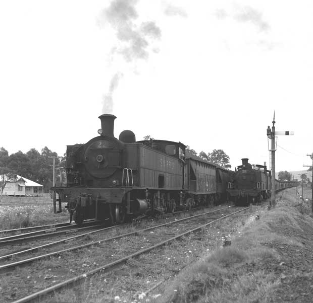 The train on the left (No. 22), is leaving Aberdare Sidings and crossing from the South Maitland Railways Down Main line to the Up Main line while the train on the right (No.31 +  another) is stopped at the signal on the South Maitland Railways mainline on the Neath side of Caledonia Station waiting for No. 22 to leave and reach Neath before being allowed to proceed. Courtesy of Brian R Andrews.